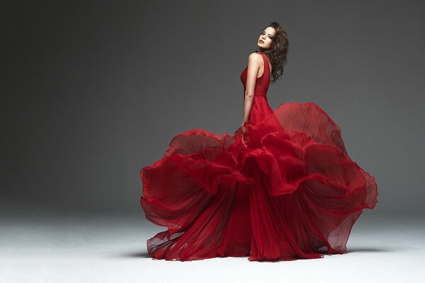 The red dress looks perfect on a gray background