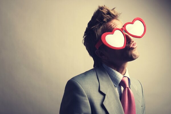 A guy in a suit and glasses in the form of hearts