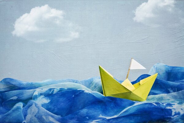 Paper boat in the blue sea