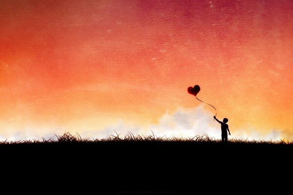 A boy on the field with a heart-shaped ball