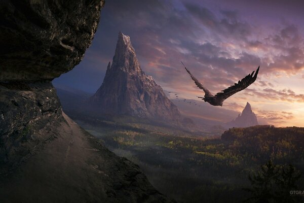 A dark bird flies into the sunset against the background of the forest and mountains