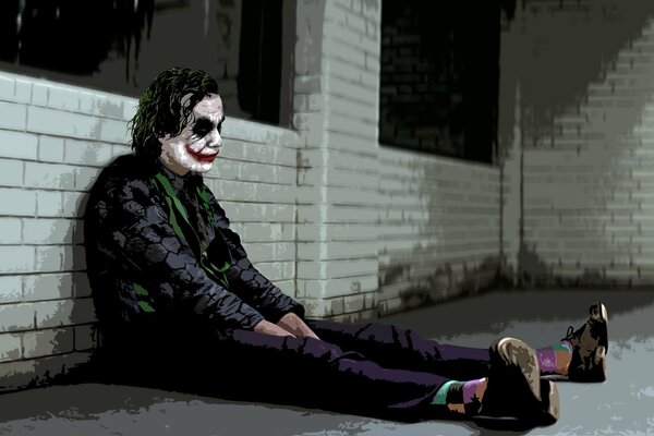 Triste Joker sentado en el Suelo