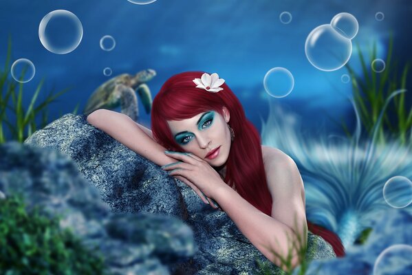 A pensive mermaid at the bottom of the ocean