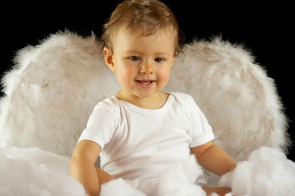 A little boy in the image of an angel for a photo