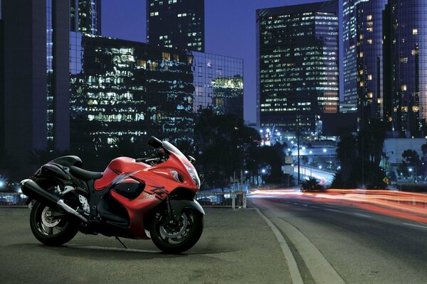 Red and black motorcycle in the night city on the road