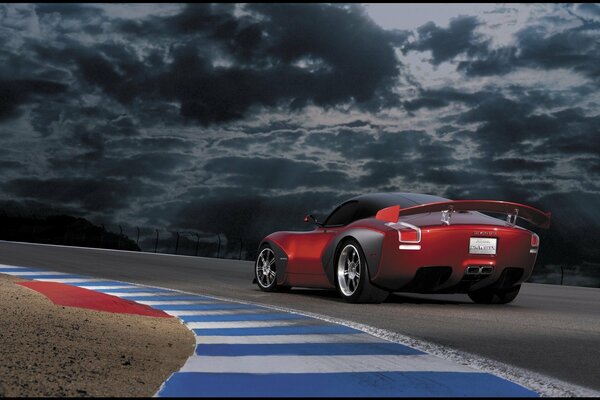 El coche rojo de carreras se corta en la pista