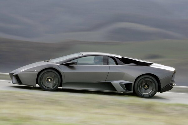 A blurry image of a gray Lamborghini at speed