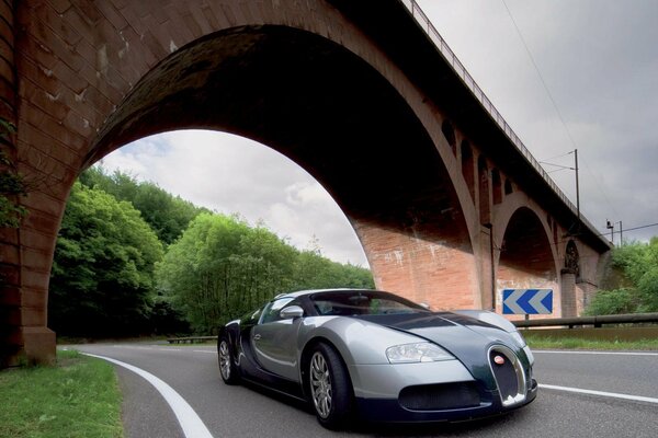 Bugatti veyron car on the background of an arched bridge