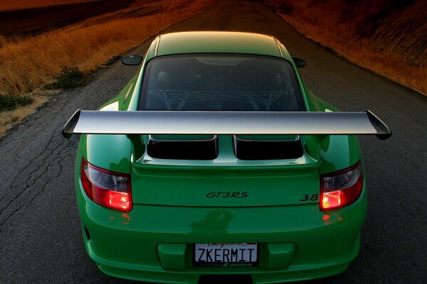 Green Porsche on a mountain road