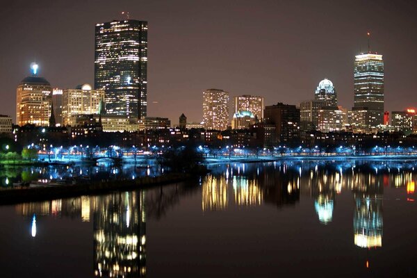 The night city is reflected in the water