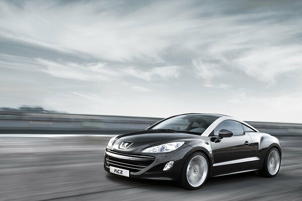 New black peugeot cuts through the autobahn