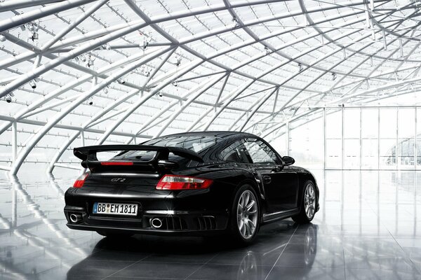 Black Porsche under a glass dome