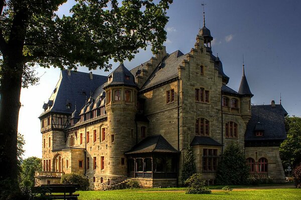 A castle with a beautiful lawn in front of it