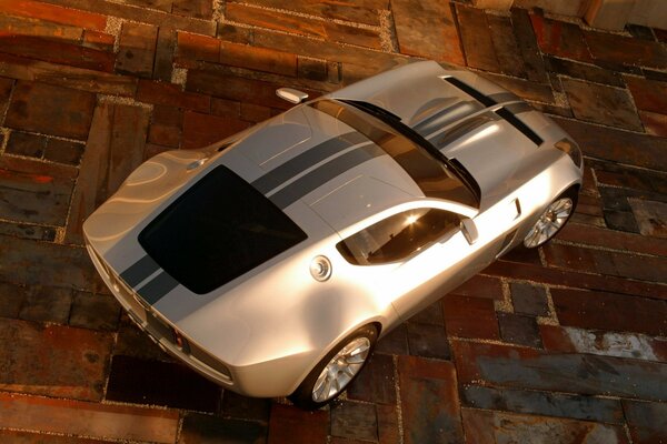 A gray Ford is standing on a tile under beautiful lighting