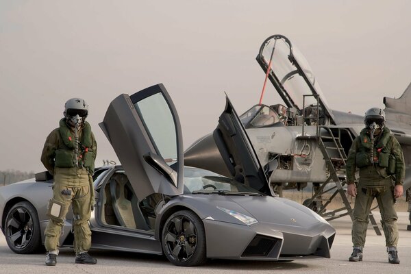 Military pilots stand near Lamborghini