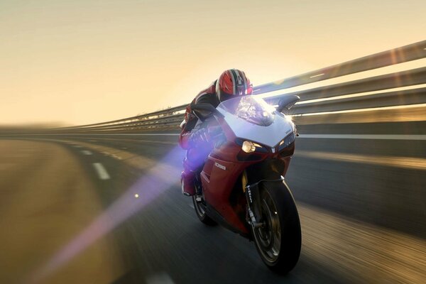 Red motorcycle racing at speed on the road