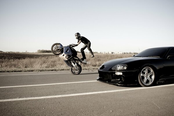 TOYOTA AND A STUNTMAN ON A MOTORCYCLE RIDING