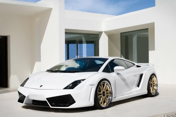 A snow-white Lamborghini on the threshold of a snow-white house