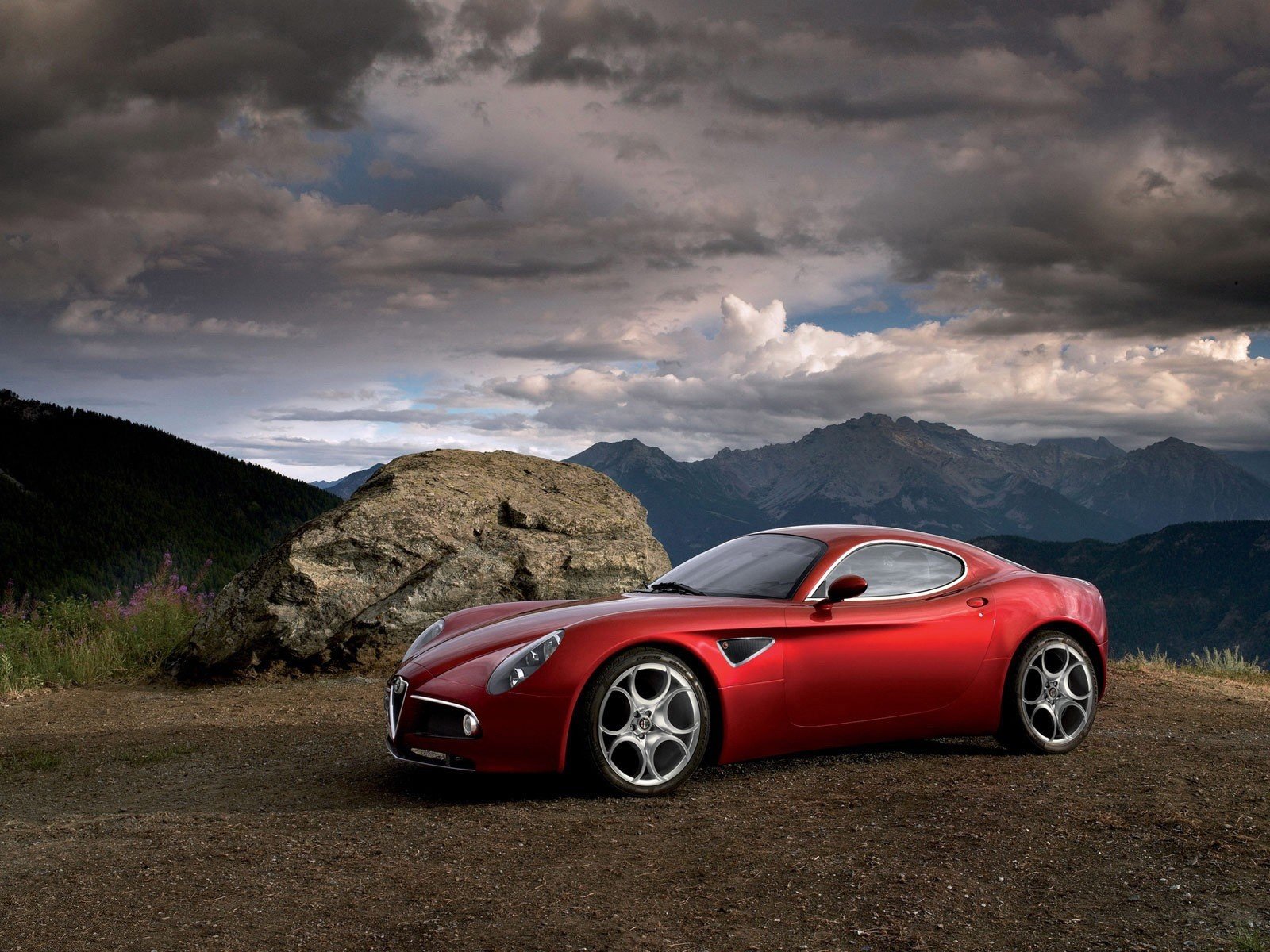 red car clouds mountain