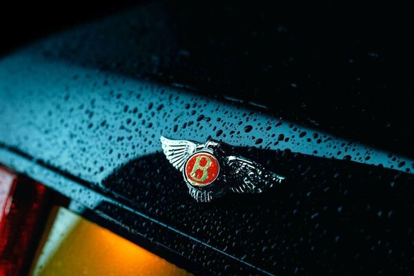 Bentley car logo. Raindrops on the car