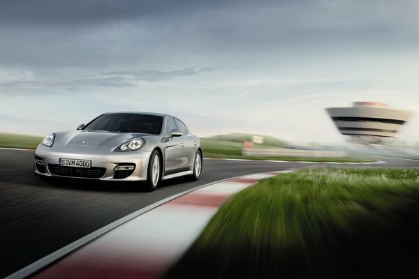 Silver Porsche on the road at high speed