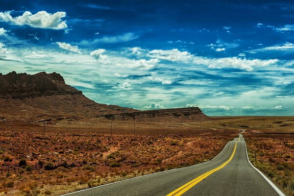 Landscape road in the desert under a blue sky