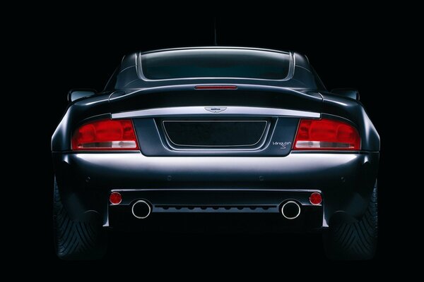 Aston Martin on a black background. Rear view