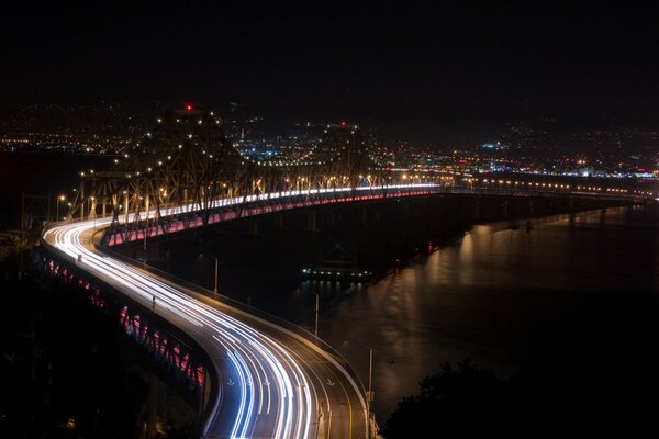 The road over the bridge over the river at night