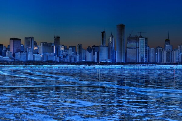 Amazing image of ice and skyscrapers of the night city