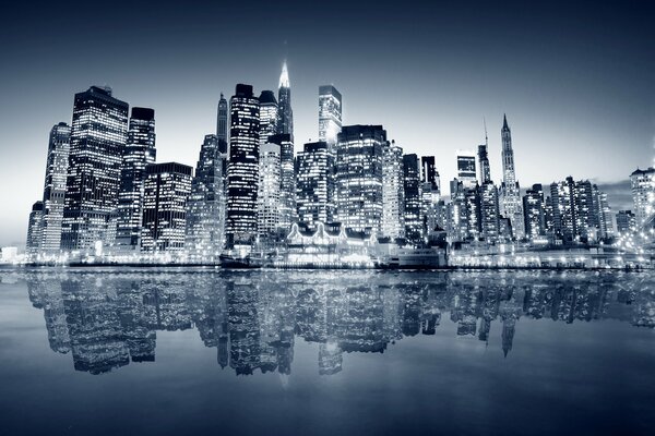 Skyscrapers in the night with reflection in the water