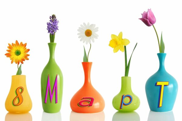 Five vases of different colors and sizes. There is a flower in each vase