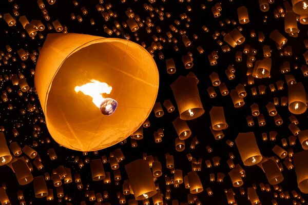 Orange sky lanterns on black