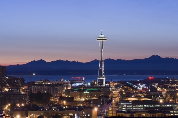 Evening Seattle tower and mountains in the distance