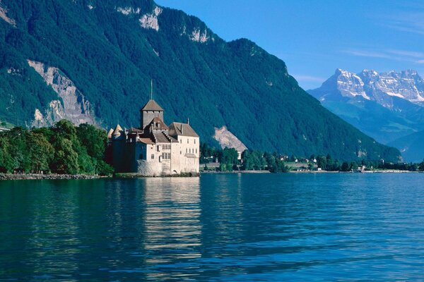 Beautiful castle by the blue lake among the mountains