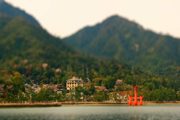 Mountain peaks and a house on the seashore