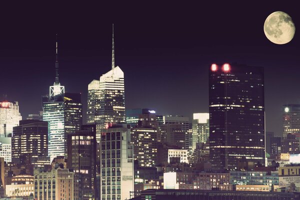 A huge moon illuminates New York at night