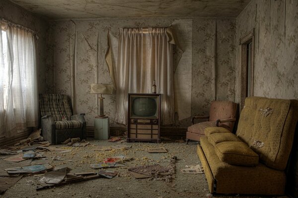 TV, sofa, armchair in an abandoned apartment