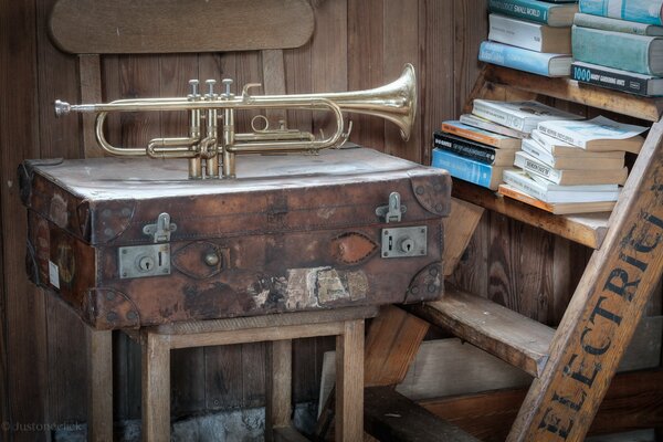 Musical trumpet on a wooden suitcase