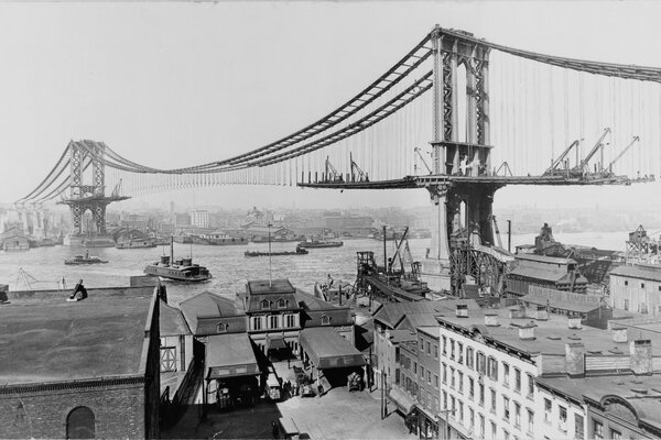 Black and white image of the construction of the Brooklyn Bridge