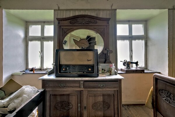 An old room with bare windows and a rare radio