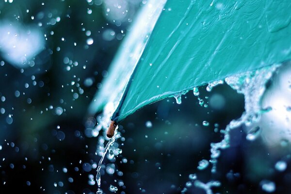 El borde de un paraguas que drena el agua de lluvia