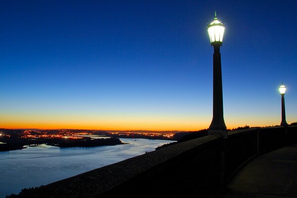 Two burning lanterns standing over the river