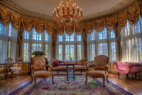 Huge living room with a beautiful design and a large chandelier