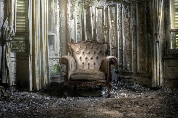 A room in ruins with a luxurious armchair