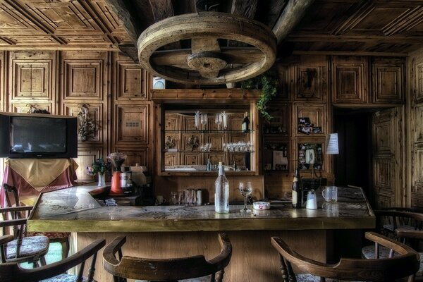 Wooden interior of a small bar with a TV