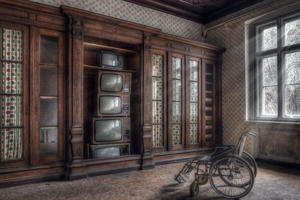 A room with old TVs with an armchair