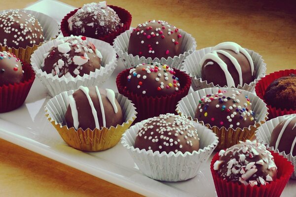 Round chocolates in paper molds Still life