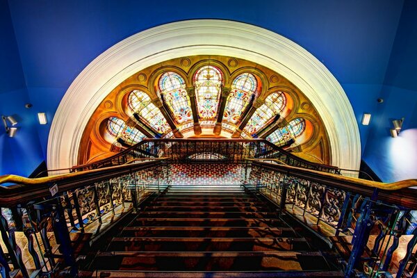 Elegant staircase on the background of stained glass