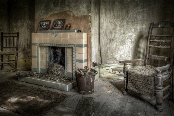 An old room with a fireplace and two chairs