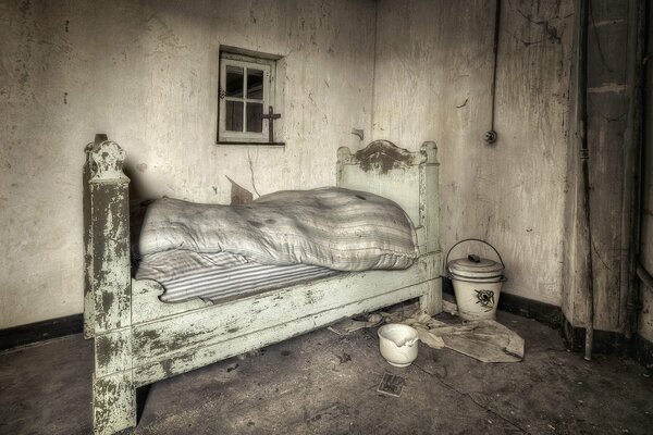 An old bed in a dark room